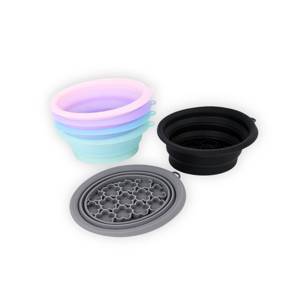 Set of silicone bowls in various colors on a white background